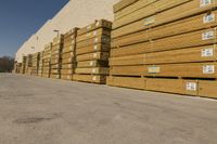 stacks of lumber are stacked up by the side of a building with white trims and tags on it