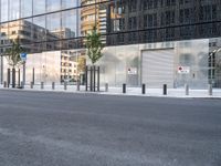 the reflection of a building on the side of a road shows a man on a skateboard