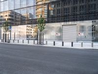 the reflection of a building on the side of a road shows a man on a skateboard