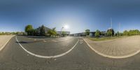 a wide angle view of a road in front of a building and a solar spot