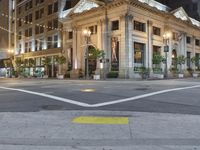 a bus stop and a fire hydrant in an empty street next to the tall buildings