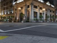 a bus stop and a fire hydrant in an empty street next to the tall buildings