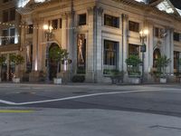 a bus stop and a fire hydrant in an empty street next to the tall buildings