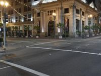 a bus stop and a fire hydrant in an empty street next to the tall buildings