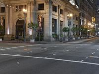 a bus stop and a fire hydrant in an empty street next to the tall buildings