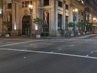 a bus stop and a fire hydrant in an empty street next to the tall buildings