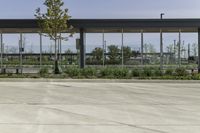 a bus stop with many windows in the background on a sunny day, it appears to be in a public transit area