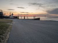 a photo of a bus that is by the water at sunset on the ocean shore