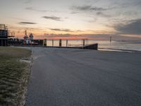 a photo of a bus that is by the water at sunset on the ocean shore