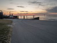 a photo of a bus that is by the water at sunset on the ocean shore