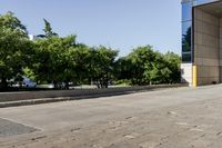 the bus station has some trees growing outside it by it's door, in front of a building