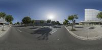 a picture of a 360 - camera shot of a street with buildings around it and a large building on the other side