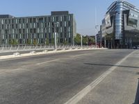 a large glass building next to a street that has a fire hydrant on it