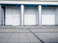 an image of empty parking lot with two cars in front of it and people walking in line