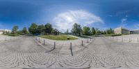 360 - view of a street with stone paths and fenced in gardens behind the roadway