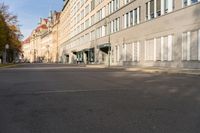 there is only one bus on this empty street in europe, and no one is waiting at this time