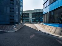 a black and blue building in an urban city with a skateboarder going around it