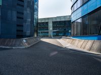 a black and blue building in an urban city with a skateboarder going around it