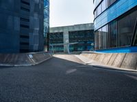 a black and blue building in an urban city with a skateboarder going around it