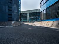 a black and blue building in an urban city with a skateboarder going around it