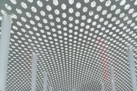 a picture of the ceiling made out of poles and lights that have polka dots on them