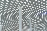 a picture of the ceiling made out of poles and lights that have polka dots on them