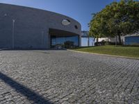 the entrance to a building with circular window windows is seen from the street in front