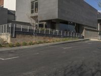 a motorcycle is parked near the curb of a street next to a building with an attached car