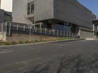 a motorcycle is parked near the curb of a street next to a building with an attached car