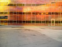 a skateboarder is in the foreground by a multi - colored building