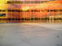 a skateboarder is in the foreground by a multi - colored building