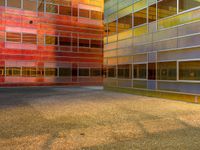 an image of a reflection of some buildings in a glass building complex that is brightly colored