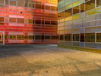 an image of a reflection of some buildings in a glass building complex that is brightly colored