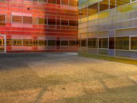 an image of a reflection of some buildings in a glass building complex that is brightly colored