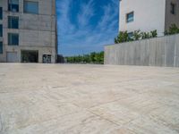 the gray concrete walls of a building have a line of steps on the left side