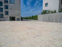 the gray concrete walls of a building have a line of steps on the left side