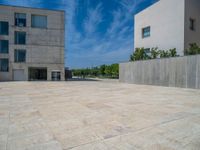 the gray concrete walls of a building have a line of steps on the left side