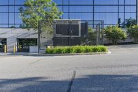 empty street in front of an office building, with large glass windows and black door