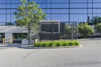 empty street in front of an office building, with large glass windows and black door