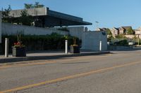 a city street with a few curb boards next to it and a building in the background