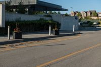 a city street with a few curb boards next to it and a building in the background