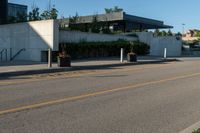 a city street with a few curb boards next to it and a building in the background