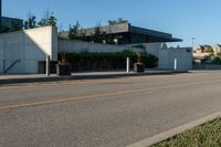 a city street with a few curb boards next to it and a building in the background