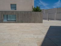 the gray concrete walls of a building have a line of steps on the left side