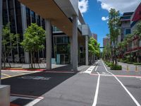 a city street with white lines painted in red and gray between two buildings and an urban area