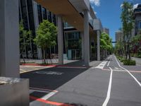 a city street with white lines painted in red and gray between two buildings and an urban area