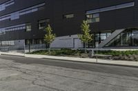 the motorcycle is parked on the street outside of the building next to it's curb