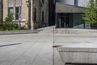 a sidewalk in front of a building with stairs up to the top of it,