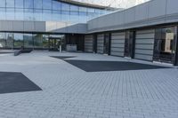 a view of an outside area of an office building with large windows and a circular driveway