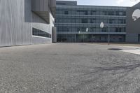 a stop sign sits in the middle of the road outside of an industrial building with glass